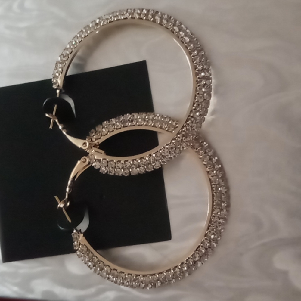 Crystal hoop earrings in gold tone.